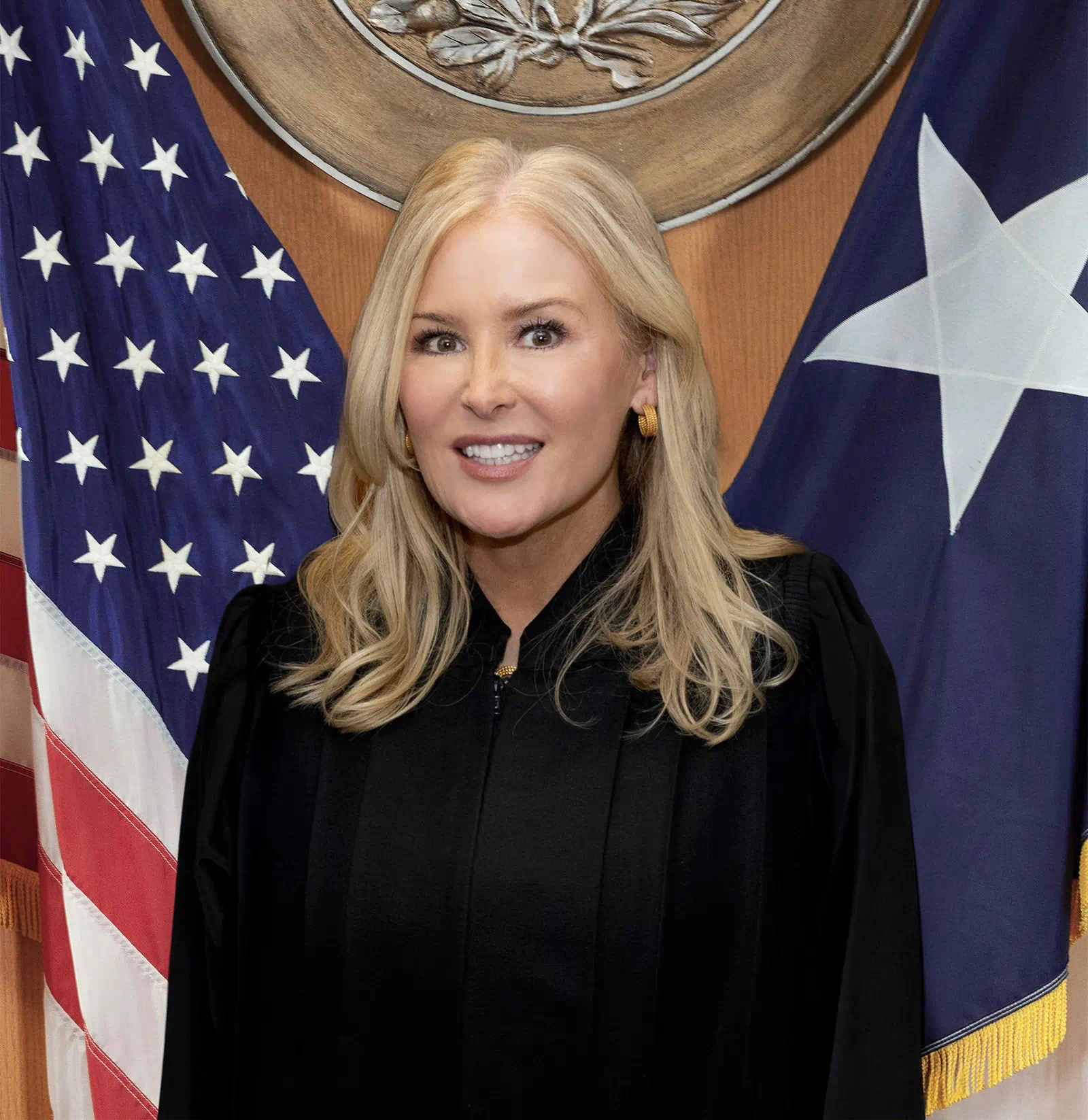 Judge Kathryn Pruitt standing in front of the American and State of Texas FlagJudge Kathryn Pruitt standing in front of the American and State of Texas Flag